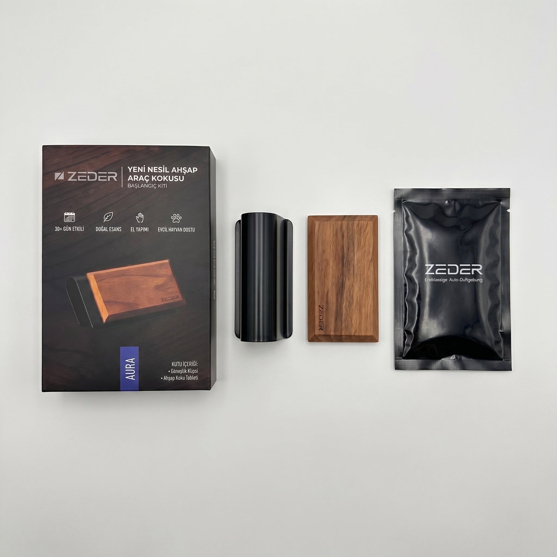 Kutu içeriği — metal klips, ahşap tablet ve AURA koku poşeti
